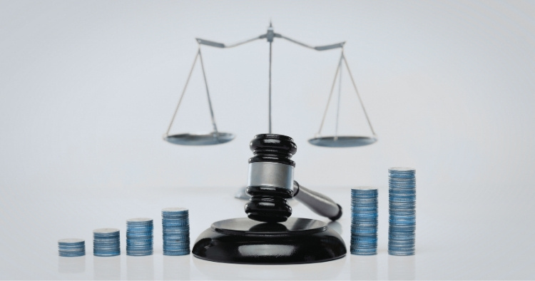 Financial compliance documents on a desk with a laptop