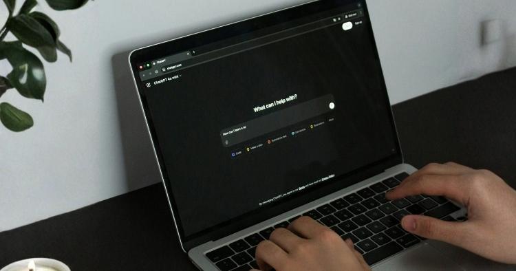 Employee using an AI tool on a laptop without IT oversight