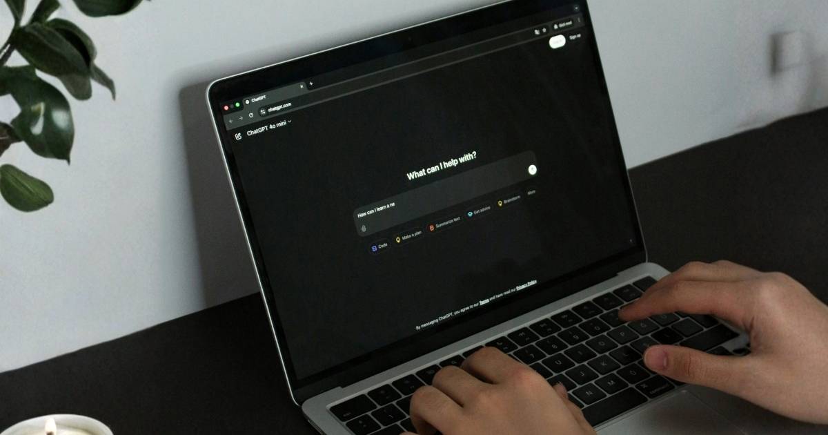 Employee using an AI tool on a laptop without IT oversight